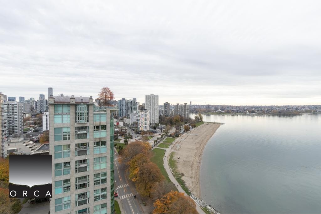 Modern high-rise waterfront condo with stunning views of the city skyline and waterfront in Vancouver, BC, available through Orca Realty Inc.