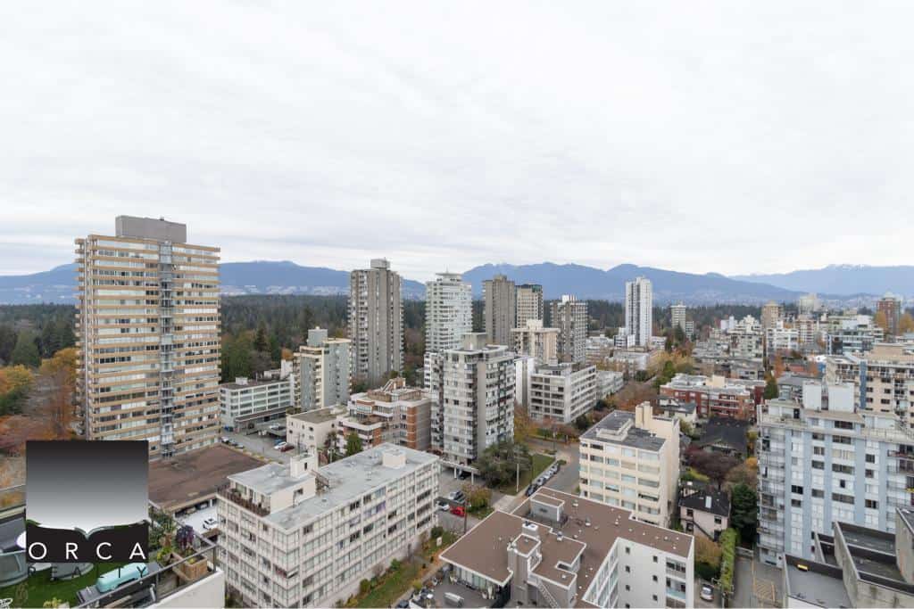 Vancouver city skyline with high-rise buildings and mountain views, representing prime real estate opportunities with Orca Realty Inc. in the Greater Vancouver Area.
