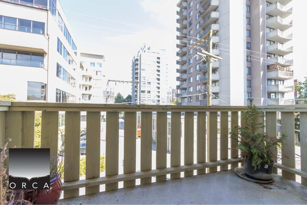 Balcony view of modern high-rise condos in downtown Vancouver, showcasing urban living and real estate opportunities with Orca Realty Inc.