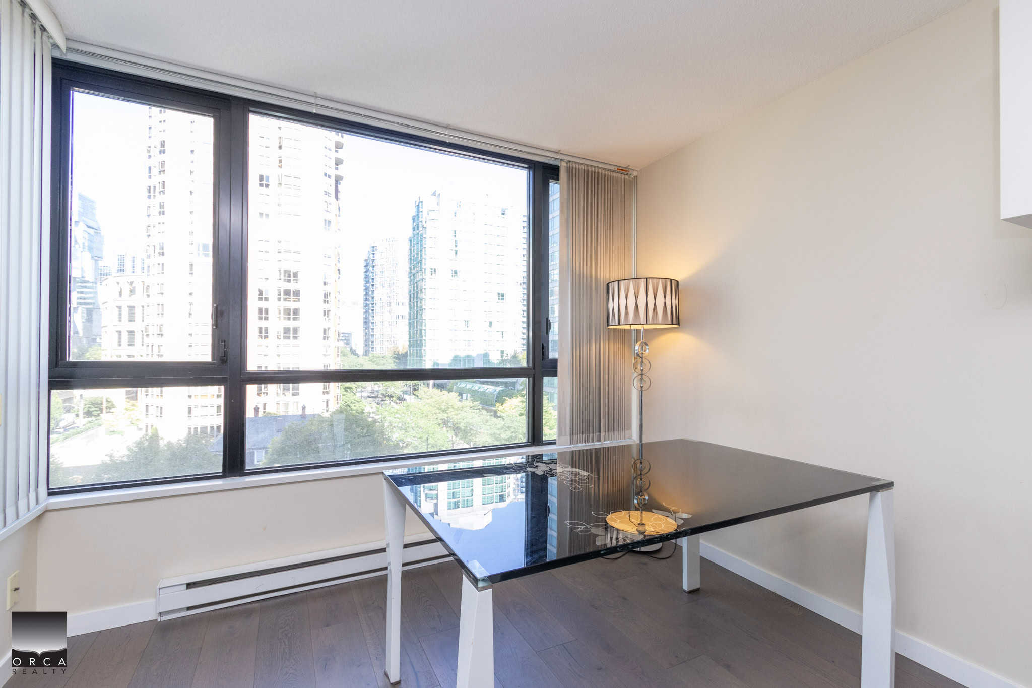 Bright city view from modern condo window with natural light, ideal for Vancouver real estate investment and downtown living in BC.