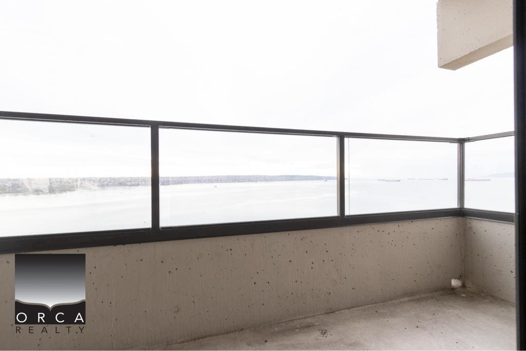 Breathtaking waterfront balcony view showcasing Vancouver Harbour, perfect for condo living with scenic ocean vistas in British Columbia.