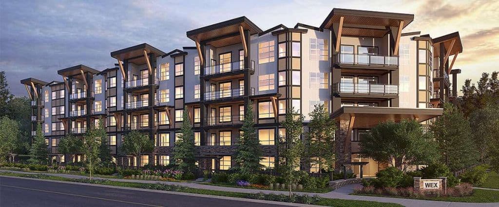 Modern multi-family residential building with contemporary architectural design, large windows, and landscaped surroundings in a serene neighbourhood.