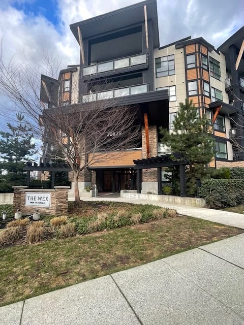 Contemporary multi-story residential building with modern architecture, large windows, and landscaped surroundings in Vancouver, BC.