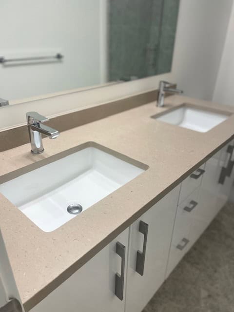 Modern bathroom vanity with dual sinks, sleek faucets, and ample storage, perfect for condo and apartment upgrades. Ideal for Vancouver real estate updates and renovation projects.