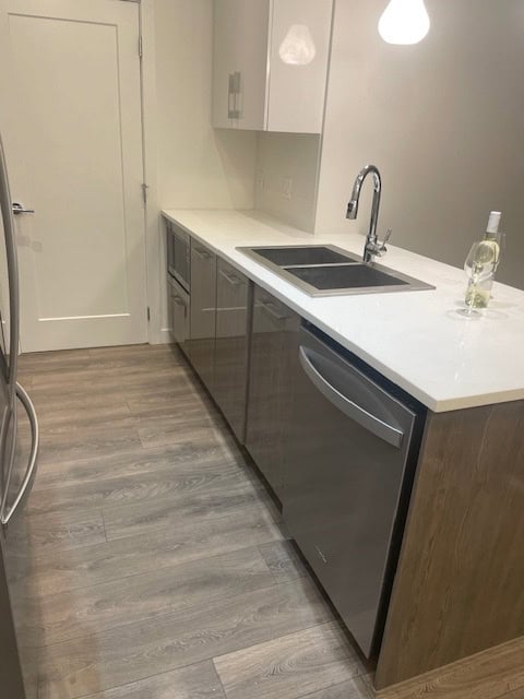 Modern kitchen with stainless steel appliances and white countertops, perfect for Vancouver homes.