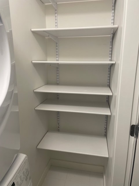 Versatile white storage shelves in a modern laundry room for optimal organisation and efficient space utilisation.