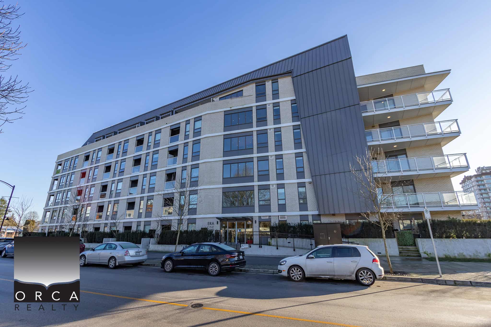 Modern multi-storey residential building in Vancouver with sleek architecture, large windows, and spacious balconies, representing prime real estate in the area.