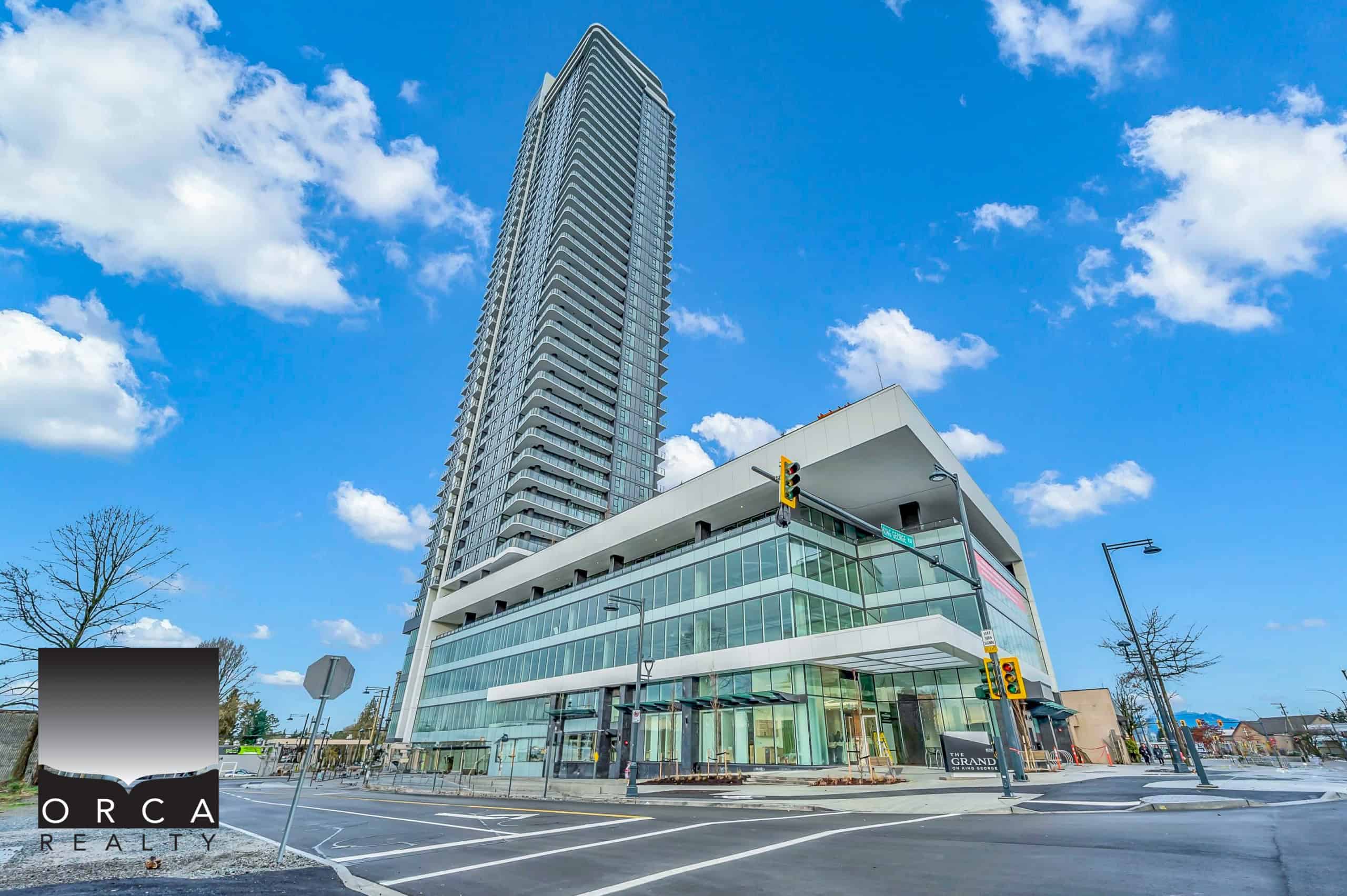 01 Contemporary high-rise condominium building featuring modern architecture with glass facades, situated in an urban setting with clear blue skies, representing prime real estate opportunities in Vancouver.