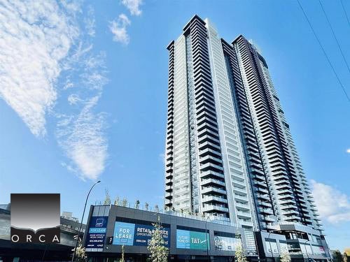 Modern high-rise apartment building with glass facade and retail spaces on the ground floor in downtown Vancouver, BC. Perfect for real estate investment, rentals, and commercial leasing opportunities.