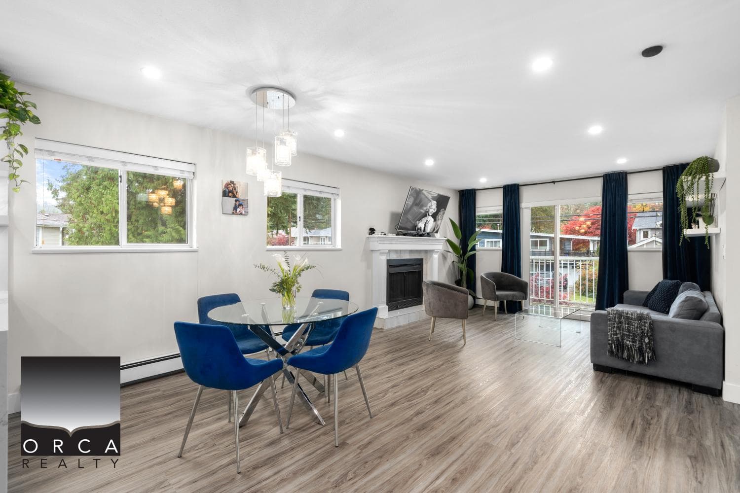 Bright open-concept living and dining area with modern furnishings, large windows, and natural light, ideal for Vancouver Island homebuyers seeking stylish property options.