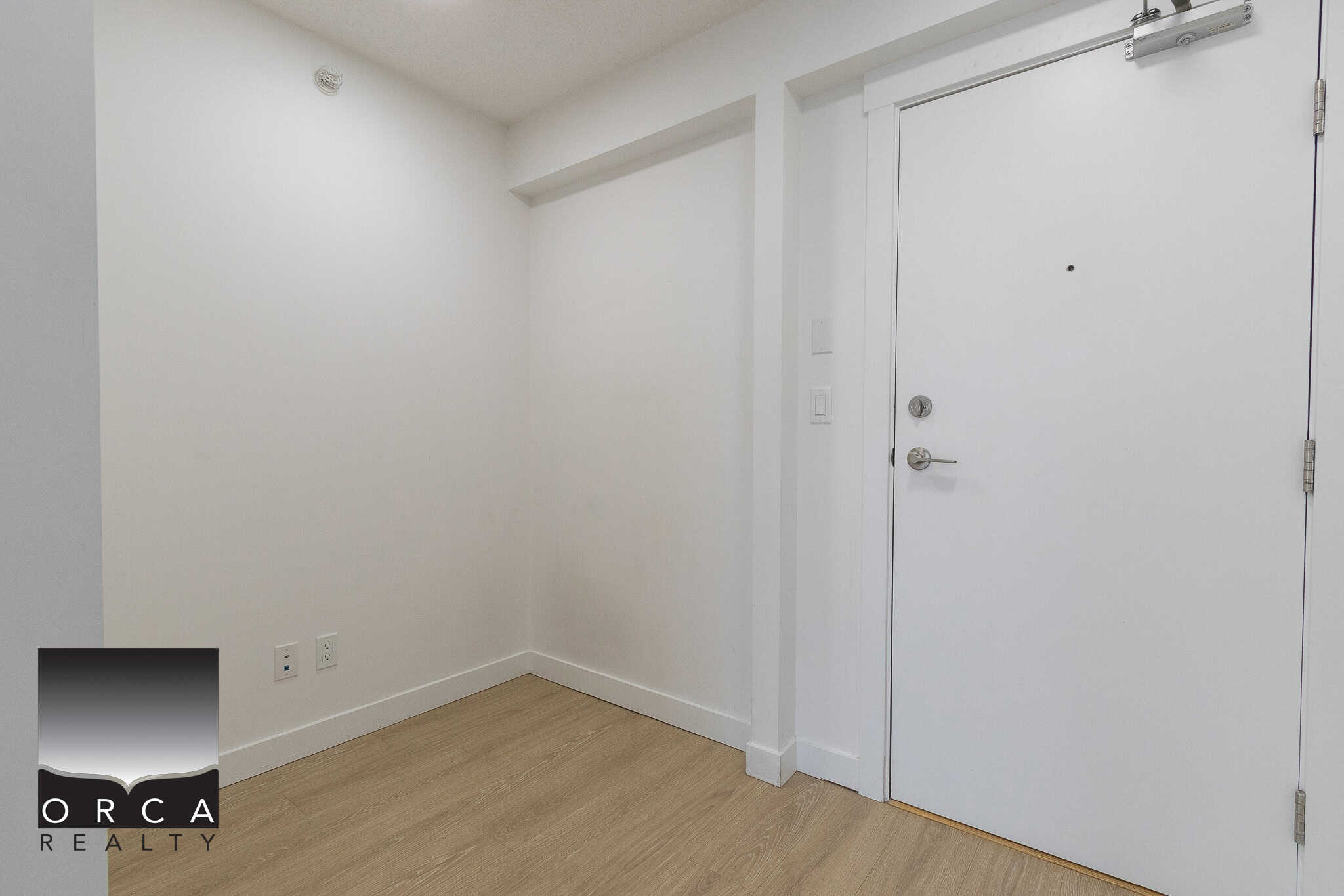 Bright white interior entryway door with clean, modern design at Orca Realty Inc., Vancouver real estate agency specializing in residential and commercial property services in BC.