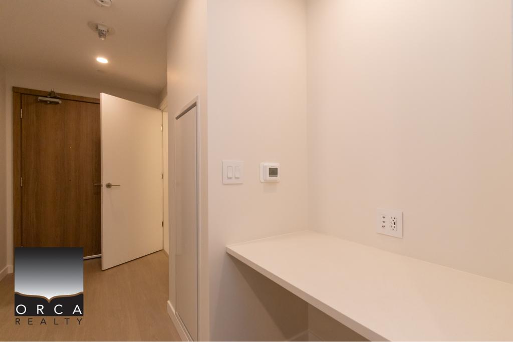 Modern interior wall with thermostat and electrical outlet at Orca Realty Inc. in Vancouver, BC. Ideal for real estate listings showcasing stylish residential property features.
