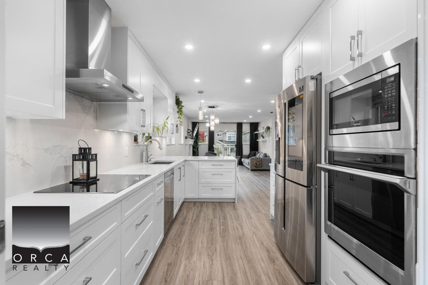 Stunning modern kitchen with white cabinetry, stainless steel appliances, and open living space, perfect for luxury home living in Vancouver.