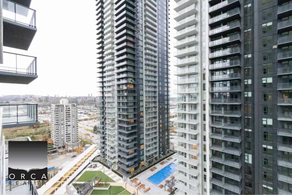 Luxurious high-rise condominium buildings with modern architecture, spacious balconies, and scenic city views in Vancouver's downtown core.