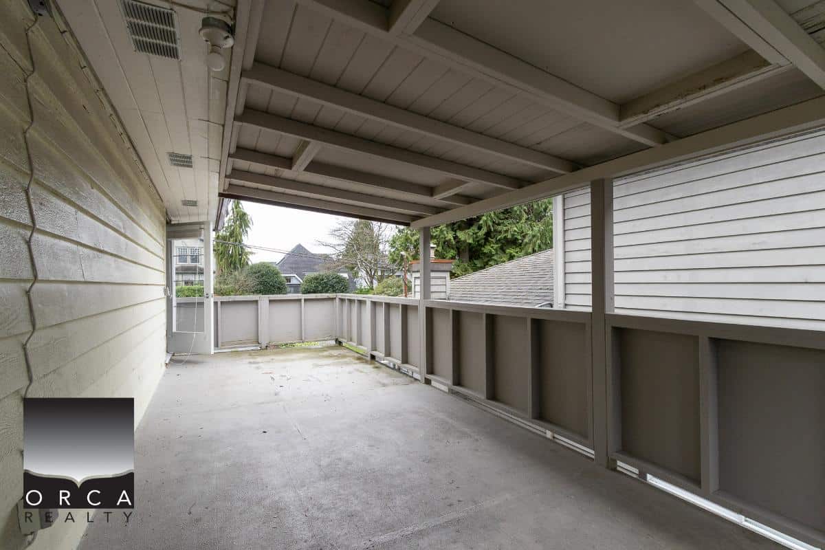 Spacious covered outdoor balcony or patio area with privacy fencing, perfect for relaxing or entertaining in a residential property listing by Orca Realty Inc.