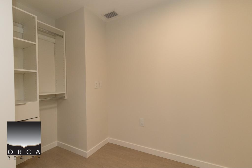 Spacious walk-in closet with built-in shelving for efficient storage in Vancouver residential property.