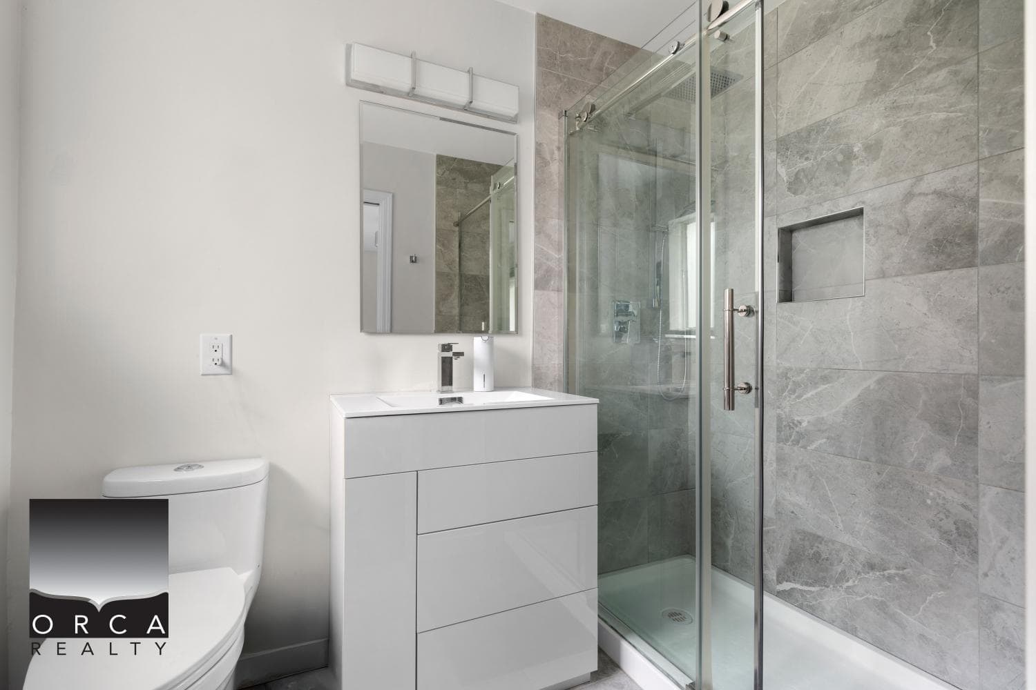 Bright modern bathroom with a sleek white vanity, walk-in glass shower, and contemporary finishes, perfect for Vancouver and Toronto real estate markets.