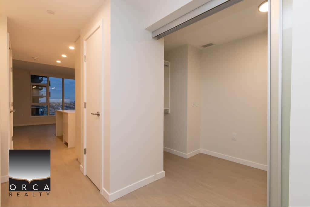 Bright modern apartment interior with large windows, ideal for real estate listings in Vancouver, BC, showcasing quality properties with Orca Realty Inc.
