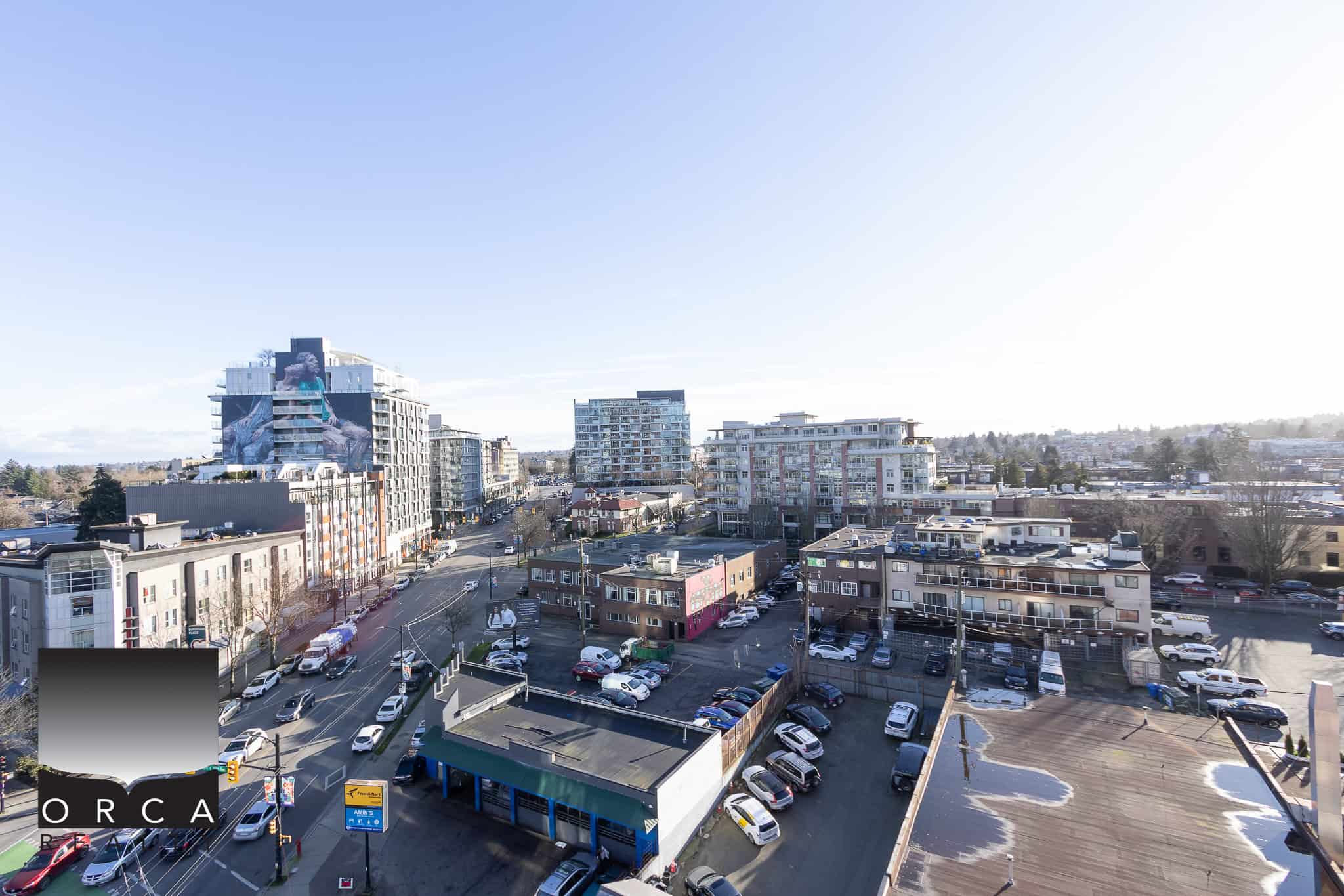 Aerial view of downtown cityscape with modern residential and commercial buildings, showcasing urban living spaces in Vancouver, Canada, featuring Orca Realty Inc. real estate services.