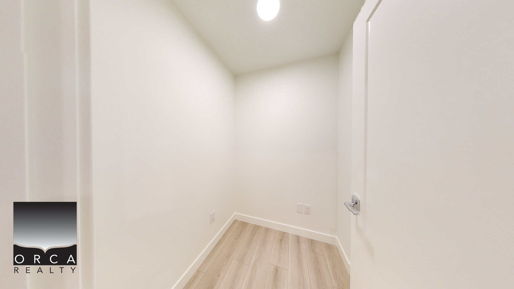 Bright empty room with white walls and light wood flooring, perfect for a home office or storage, showcasing modern interior design and a clean, minimalist look.
