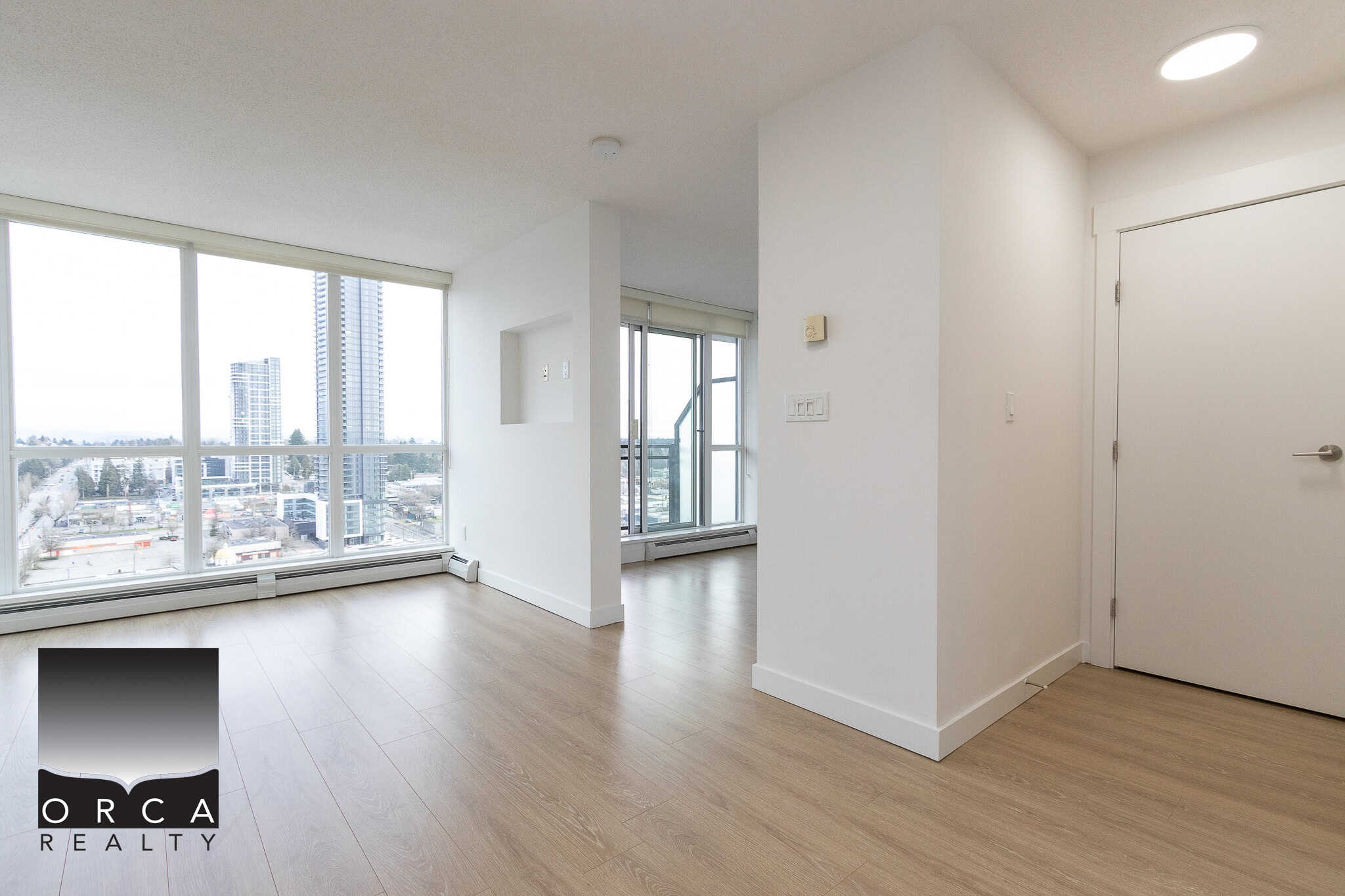 Spacious modern apartment with large windows offering city views and natural light in Vancouver, BC. Ideal for urban living with open floor plan and contemporary design.