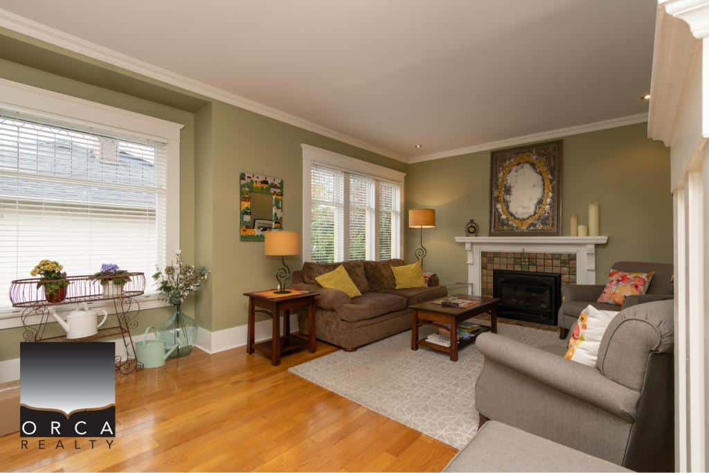 Cozy living room with large windows and hardwood floors showcasing a welcoming interior for real estate listings.
