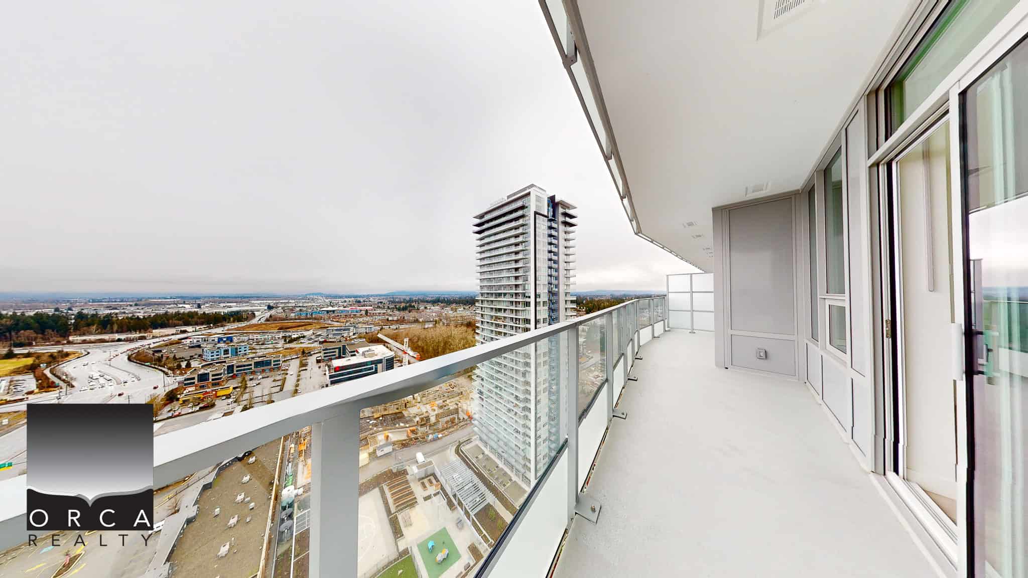 Stunning high-rise balcony with panoramic city views, modern design, and glass railing, perfect for luxury Vancouver real estate living. Ideal for real estate investors and homeowners seeking upscale properties.