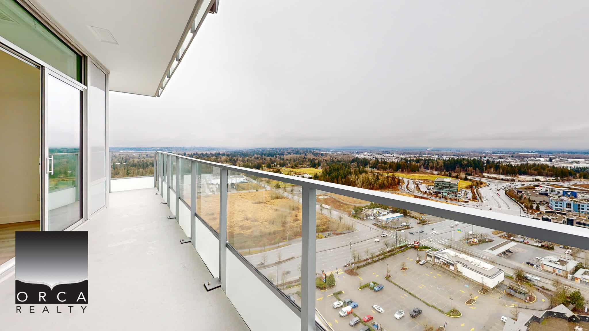 Stunning high-rise balcony with panoramic views of city and natural landscape, ideal for modern living, situated in a prime location offered by Orca Realty Inc.