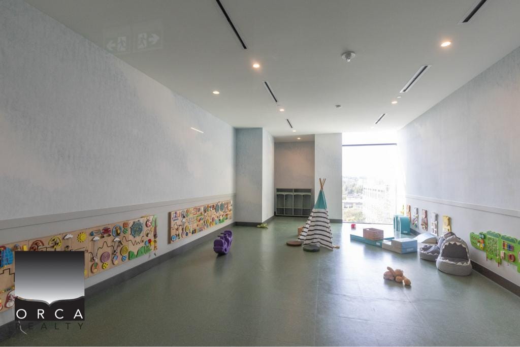 Bright indoor children's play area with colorful wall panels, soft mats, and toys, perfect for family-friendly properties and residential real estate in Victoria, BC.