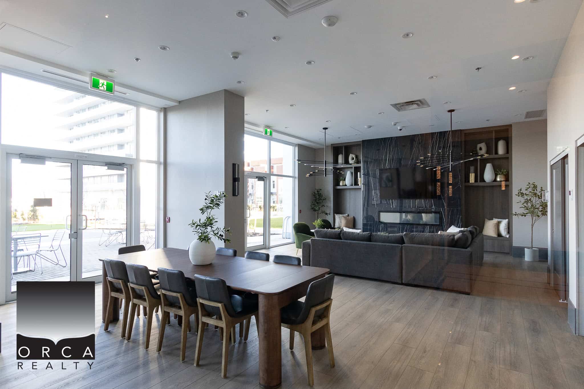 Stylish modern lobby area with contemporary decor, large windows, and comfortable seating, perfect for residential or commercial real estate clients.