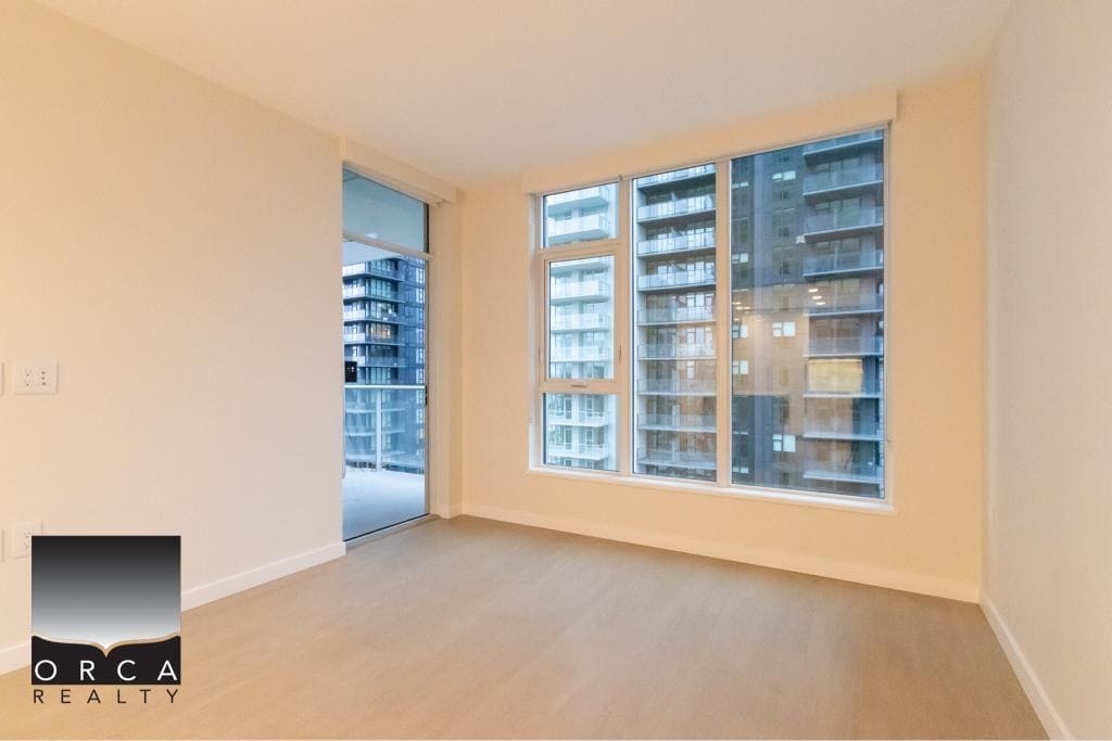 Modern downtown Vancouver condo with large windows offering city views, ideal for urban living and property investment in British Columbia.