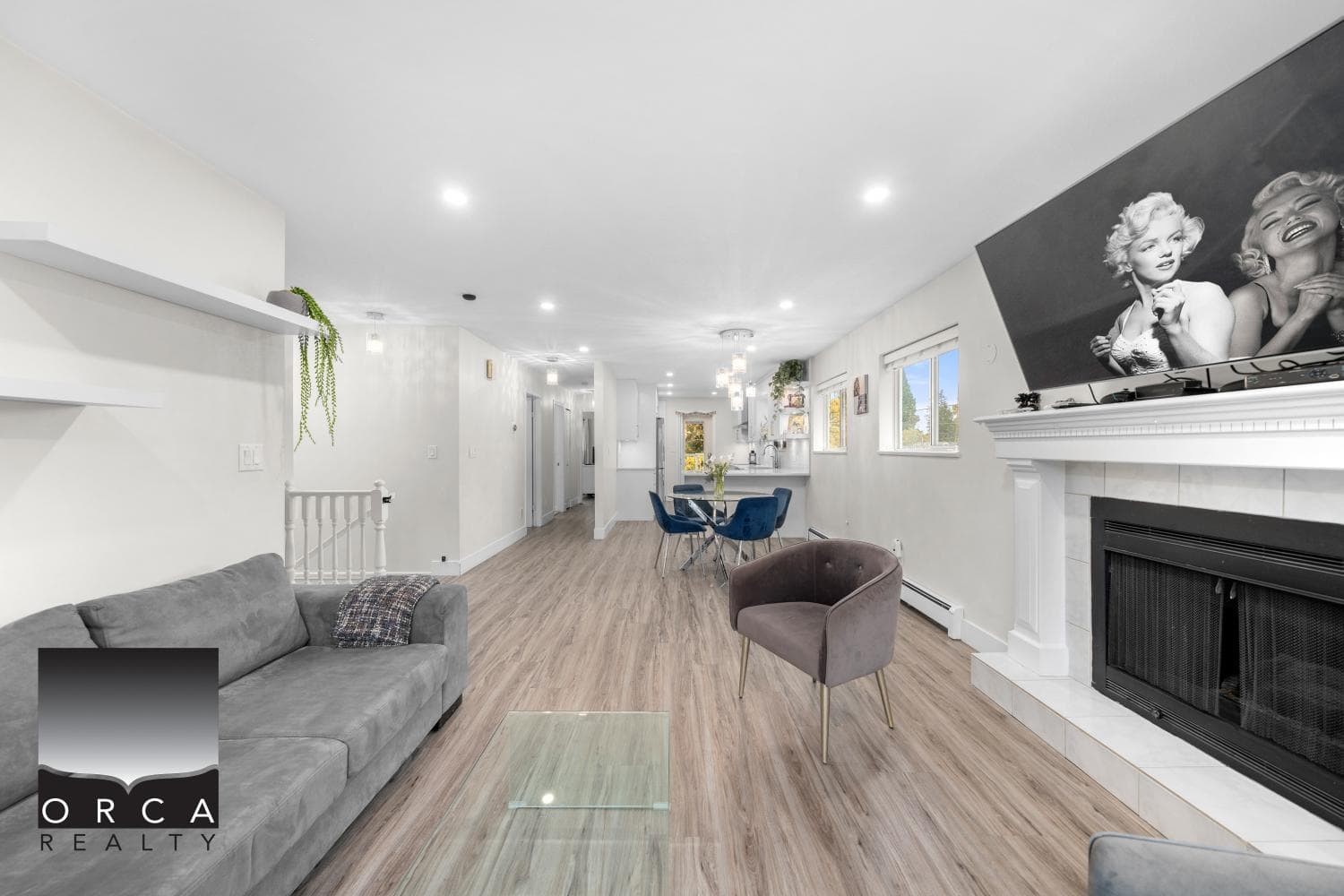 Bright and spacious modern living room with hardwood floors, fireplace, large windows, and stylish decor, perfect for family gatherings and entertaining in Vancouver' real estate market.