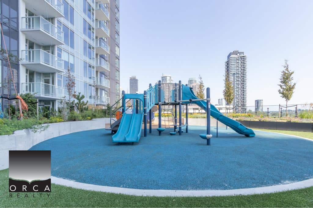 Modern rooftop playground with slides and climbing structures in a Vancouver high-rise residential complex, ideal for families and outdoor recreation.