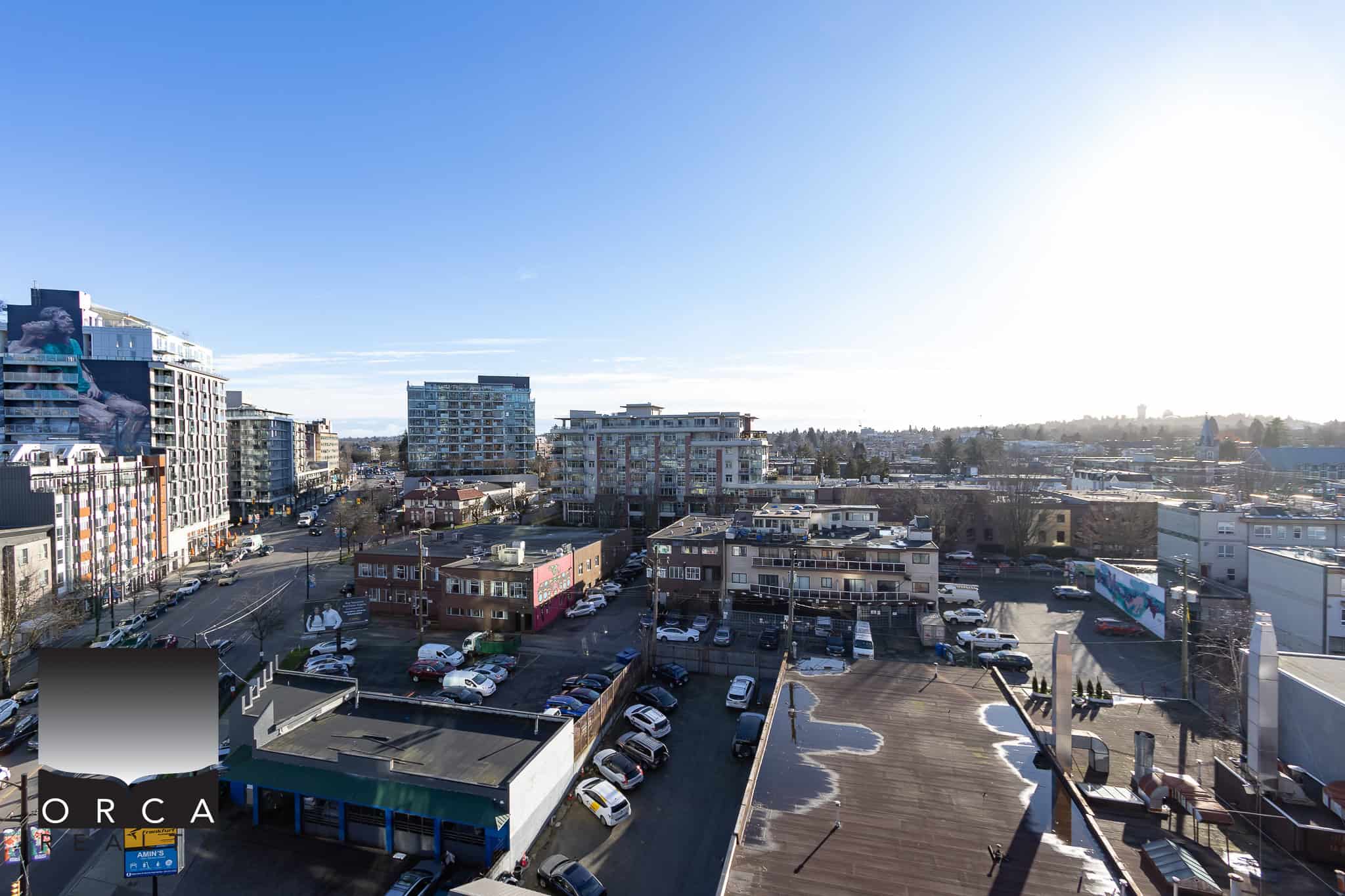Vibrant cityscape view featuring modern residential and commercial buildings, emphasizing urban living, real estate, and property opportunities in the Greater Vancouver area, captured by Orca Realty Inc.