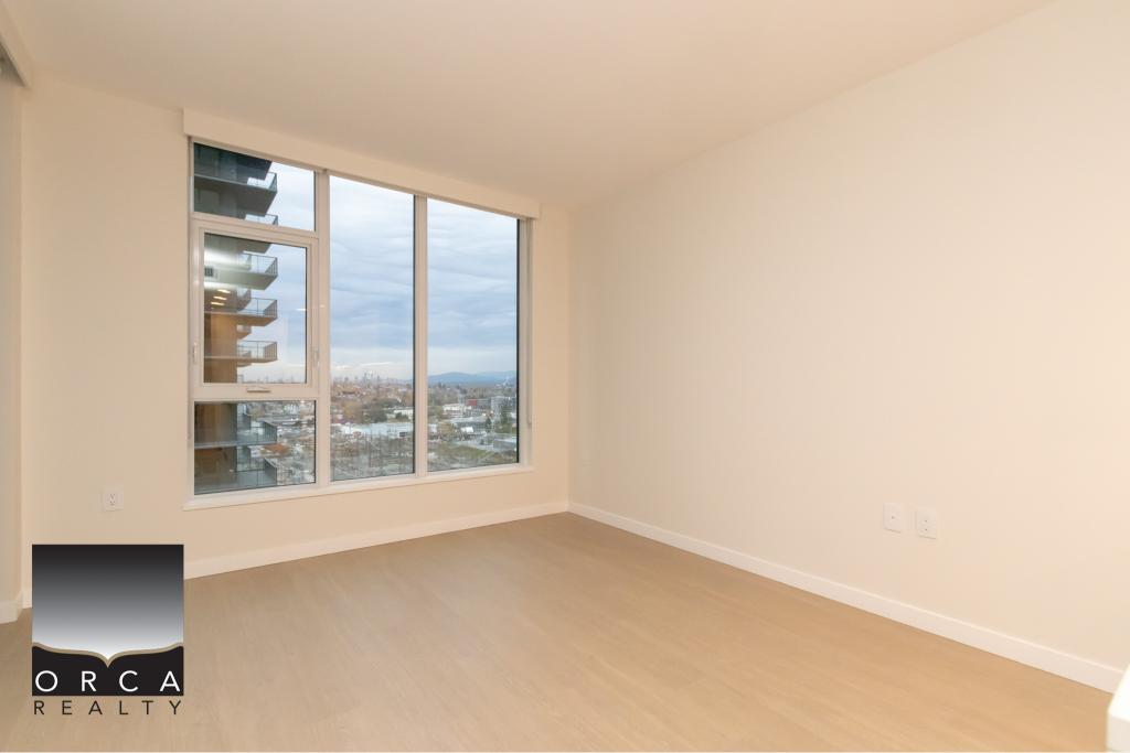 Bright empty apartment room with large floor-to-ceiling windows, showcasing city views, ideal for Vancouver real estate, offered by Orca Realty Inc.
