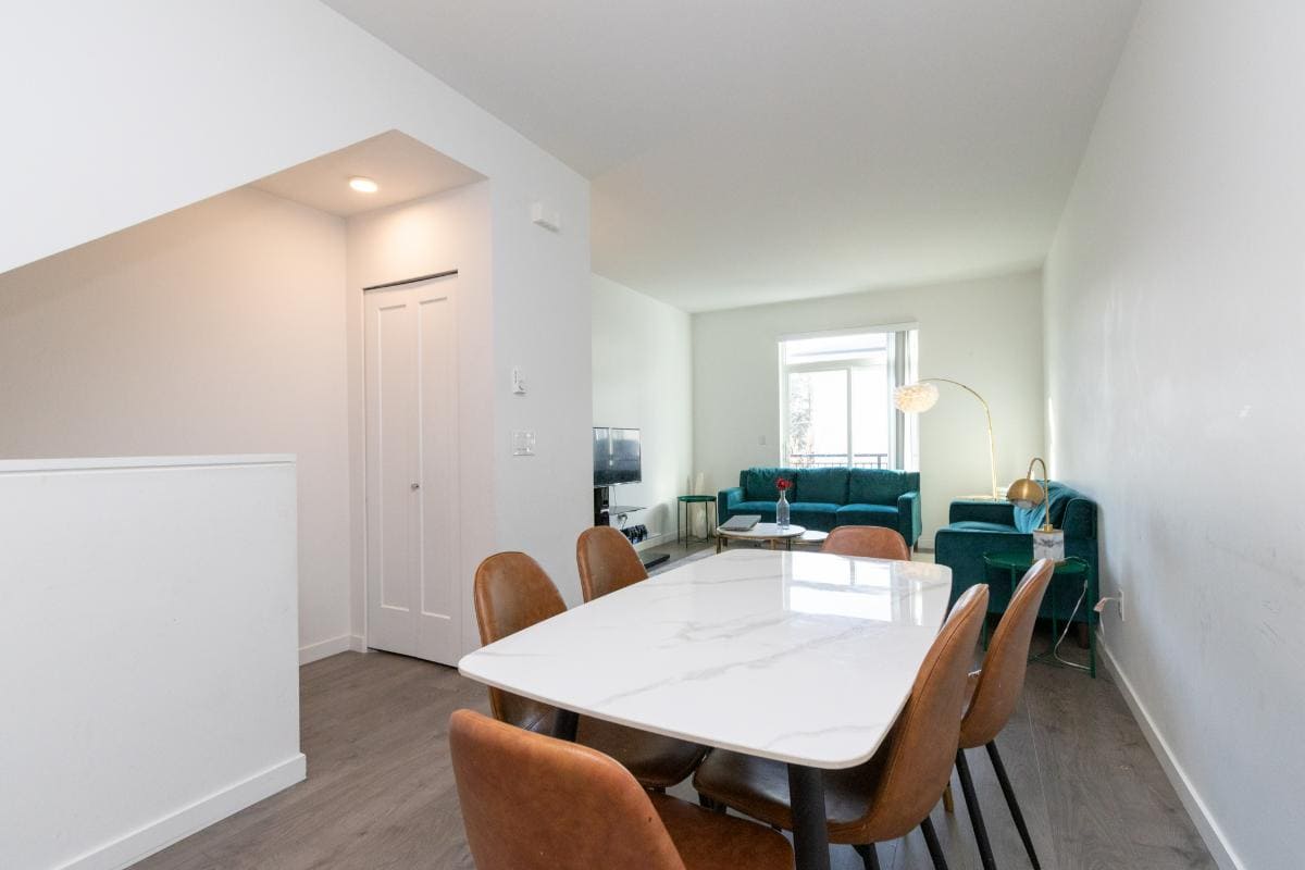 Bright and modern living and dining area in a Vancouver home, featuring stylish decor, ample natural light, and open-concept design perfect for family living and entertaining.