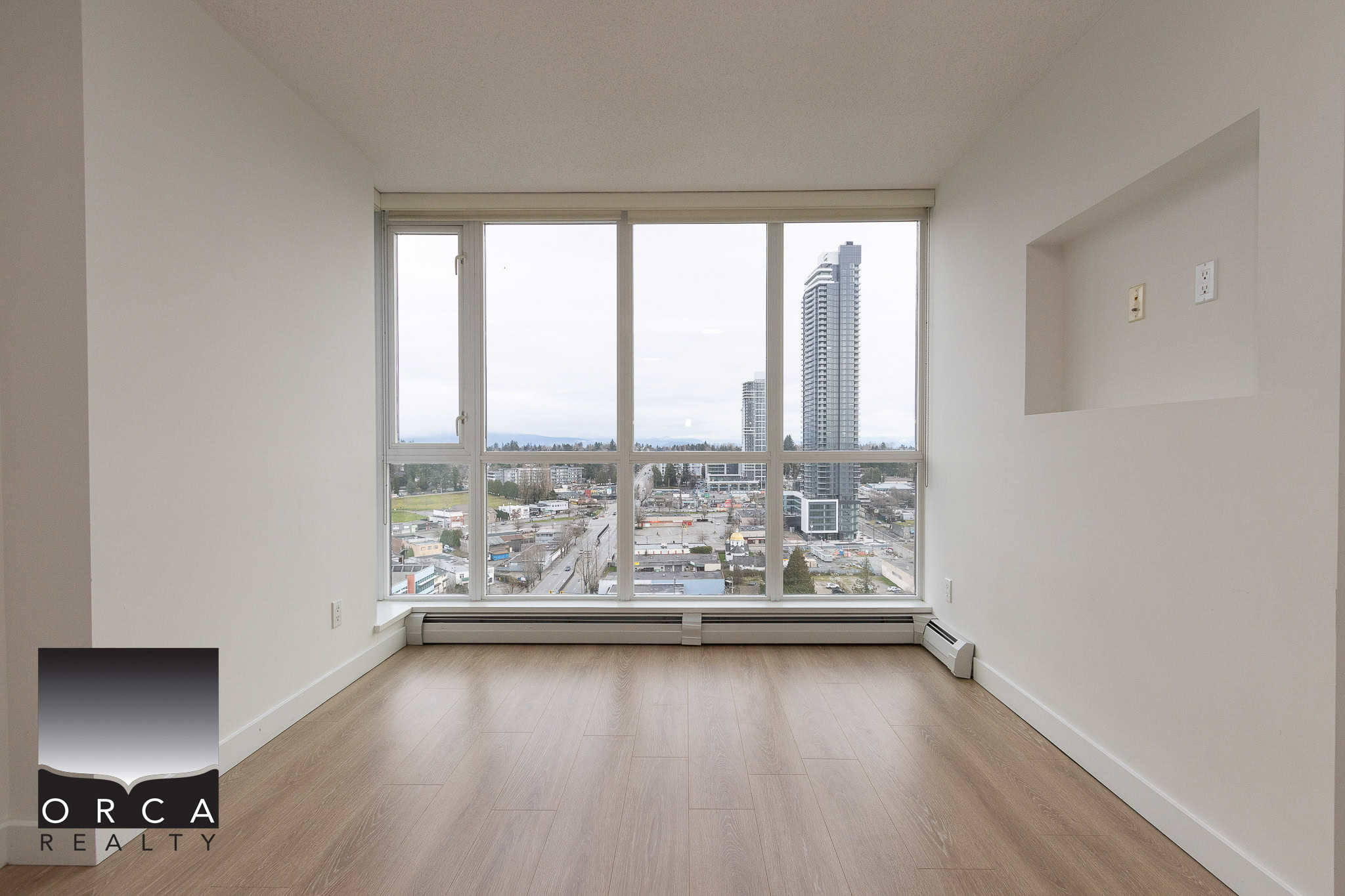 Bright high-rise apartment with large windows offering city views, modern flooring, in-unit heating, and a prime Vancouver location, ideal for real estate investment or upscale living.