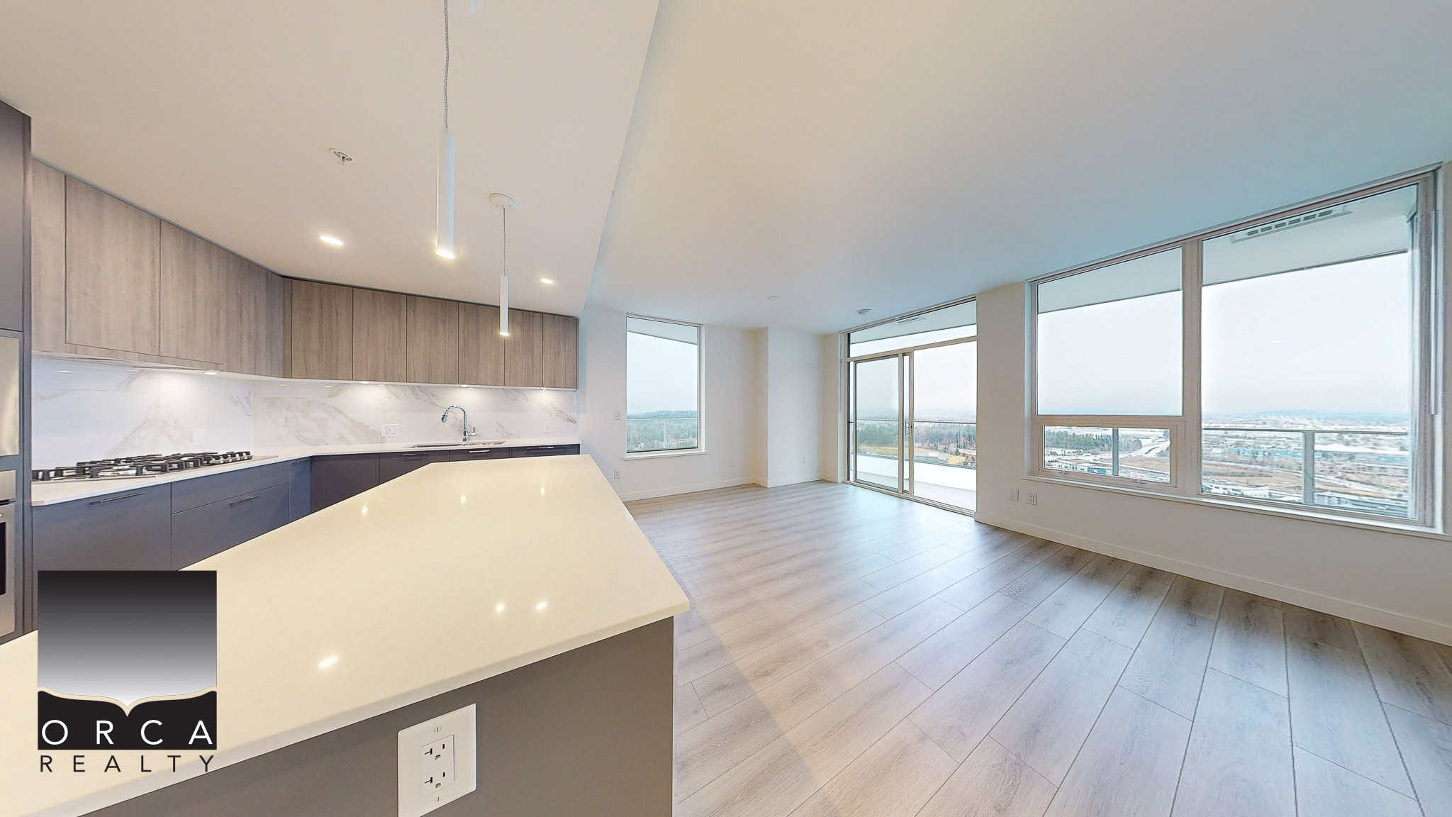 Spacious modern apartment with open-concept living area and large windows offering panoramic city views showing natural light and urban scenery.