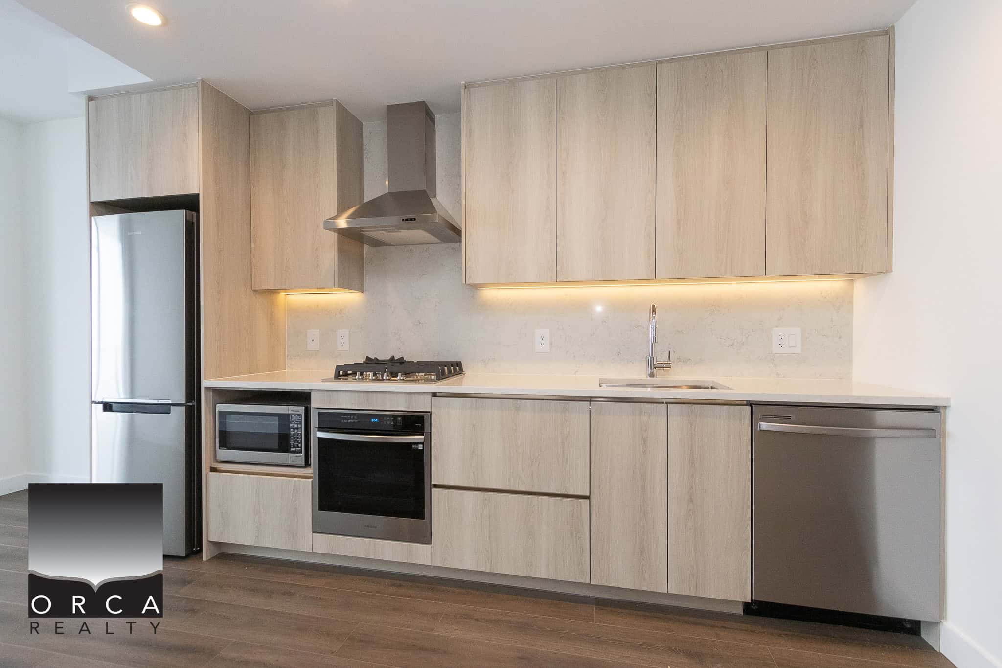 9 Modern minimalist kitchen with light wood cabinetry, stainless steel appliances, and a sleek white marble backsplash, perfect for contemporary Vancouver Island home living.