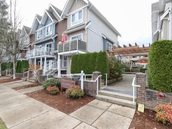 Charming multi-family residential complex in Victoria, BC with well-maintained exterior, balconies, and landscaped grounds, ideal for homebuyers and investors seeking Vancouver Island real estate.