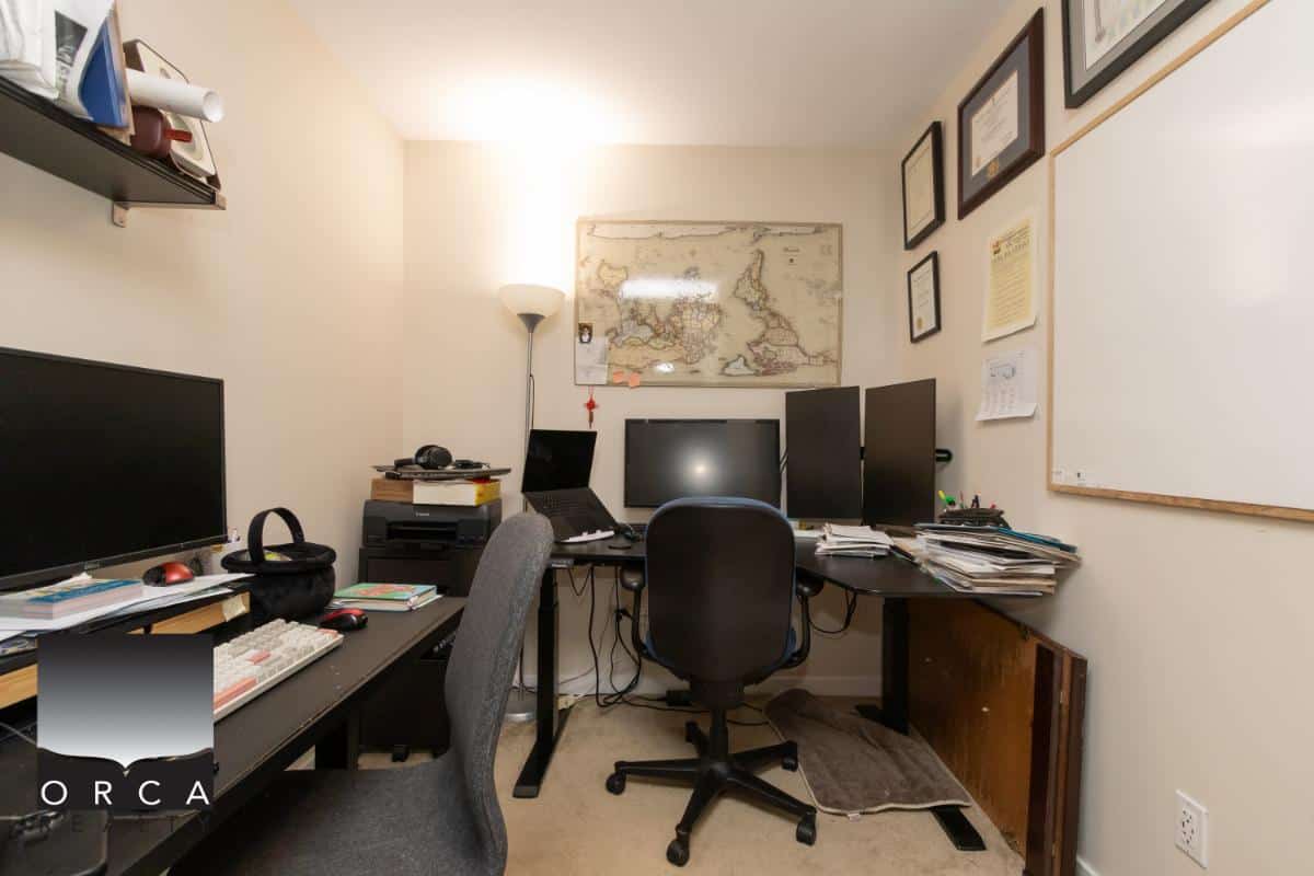 Computer home office setup with dual monitors, office chairs, and organized workspace for real estate professionals.