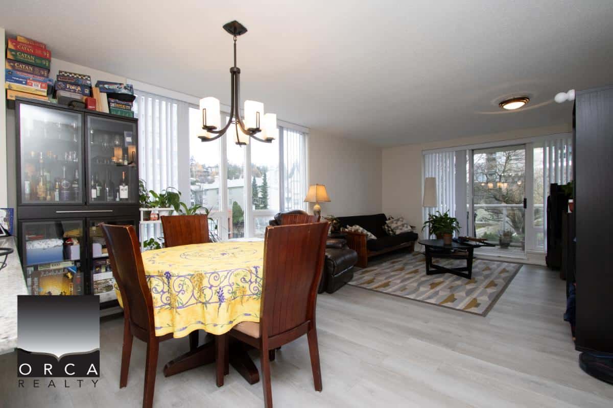 Bright open-concept living and dining area in a Vancouver home, featuring large windows, hardwood floors, modern furnishings, and natural light, perfect for family gatherings and entertaining.