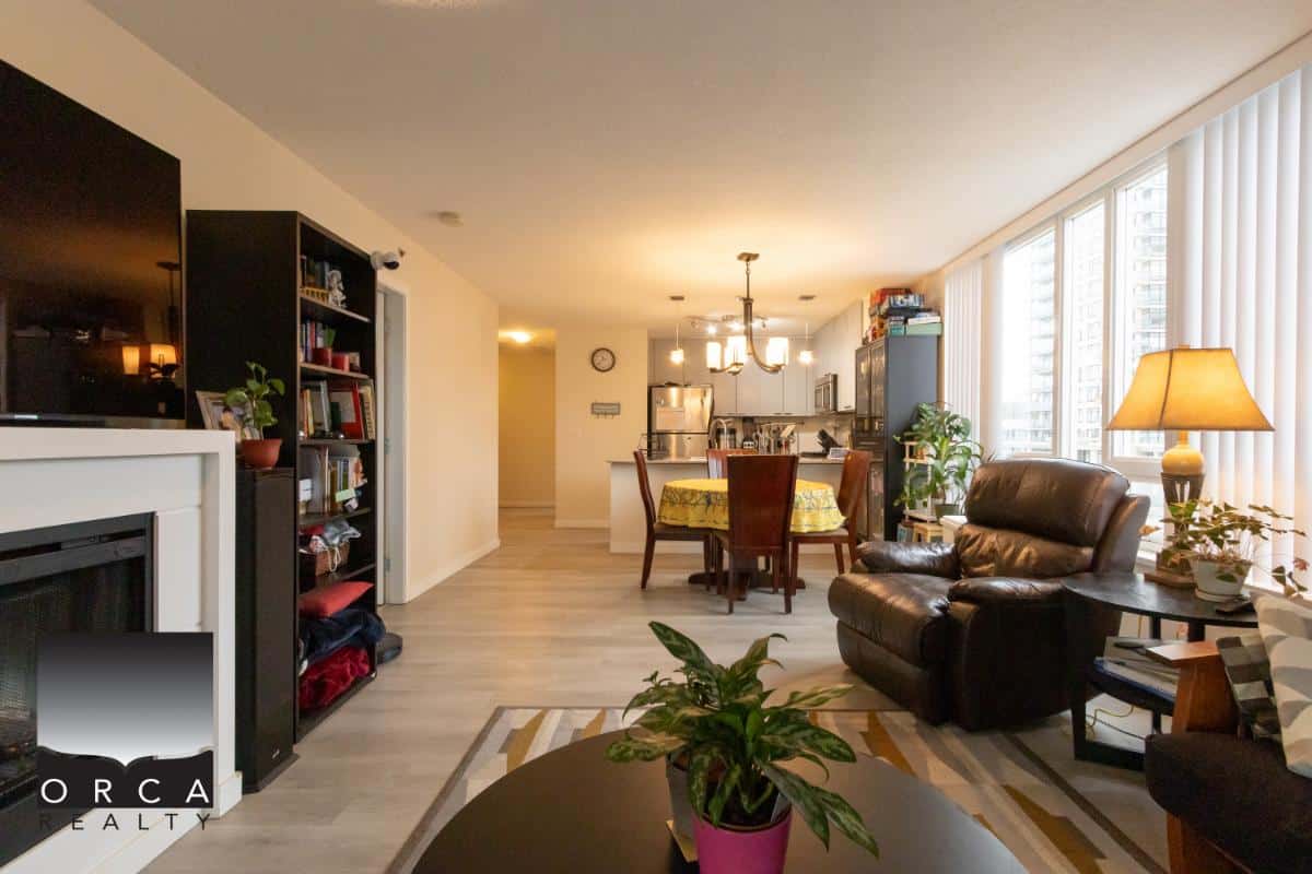 Bright and spacious living room with large windows, hardwood floors, and modern decor, ideal for urban condo living in Vancouver and surrounding areas.