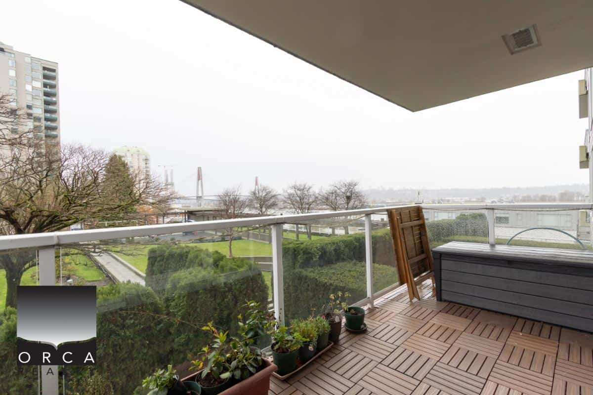 Bright balcony view of Vancouver skyline with a lush green park, perfect for enjoying outdoor living and real estate investments in BC.