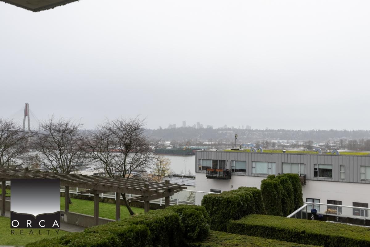 Lakeside urban residential view in Vancouver, BC with modern apartments, lush landscaping, and scenic water backdrop.