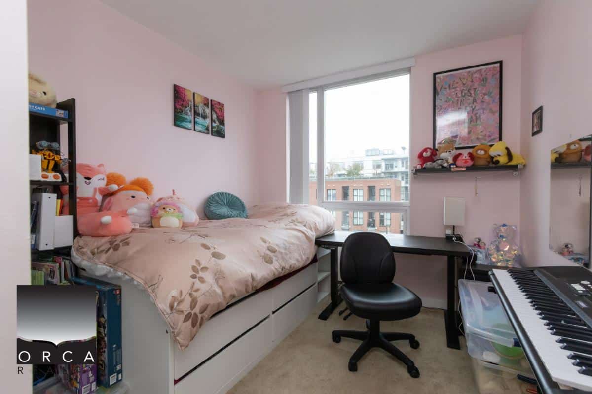 Colourful bedroom with plush toys and window views, featuring a bed, desk, bookshelf, and keyboard, ideal for families and students seeking Vancouver-area real estate.