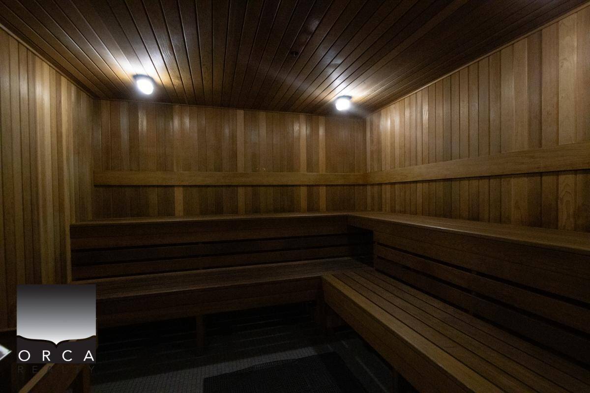 A cozy indoor wooden sauna with warm lighting, perfect for relaxation and wellness. Suitable for clients seeking serene leisure environments and expert real estate services in BC.