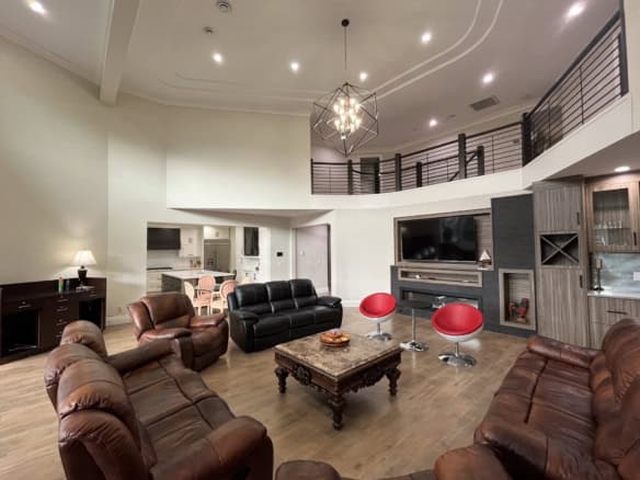 Elegant living room with modern and cozy furniture, high ceilings, and stylish lighting, showcasing luxury home interiors by Orca Realty Inc. in Vancouver.