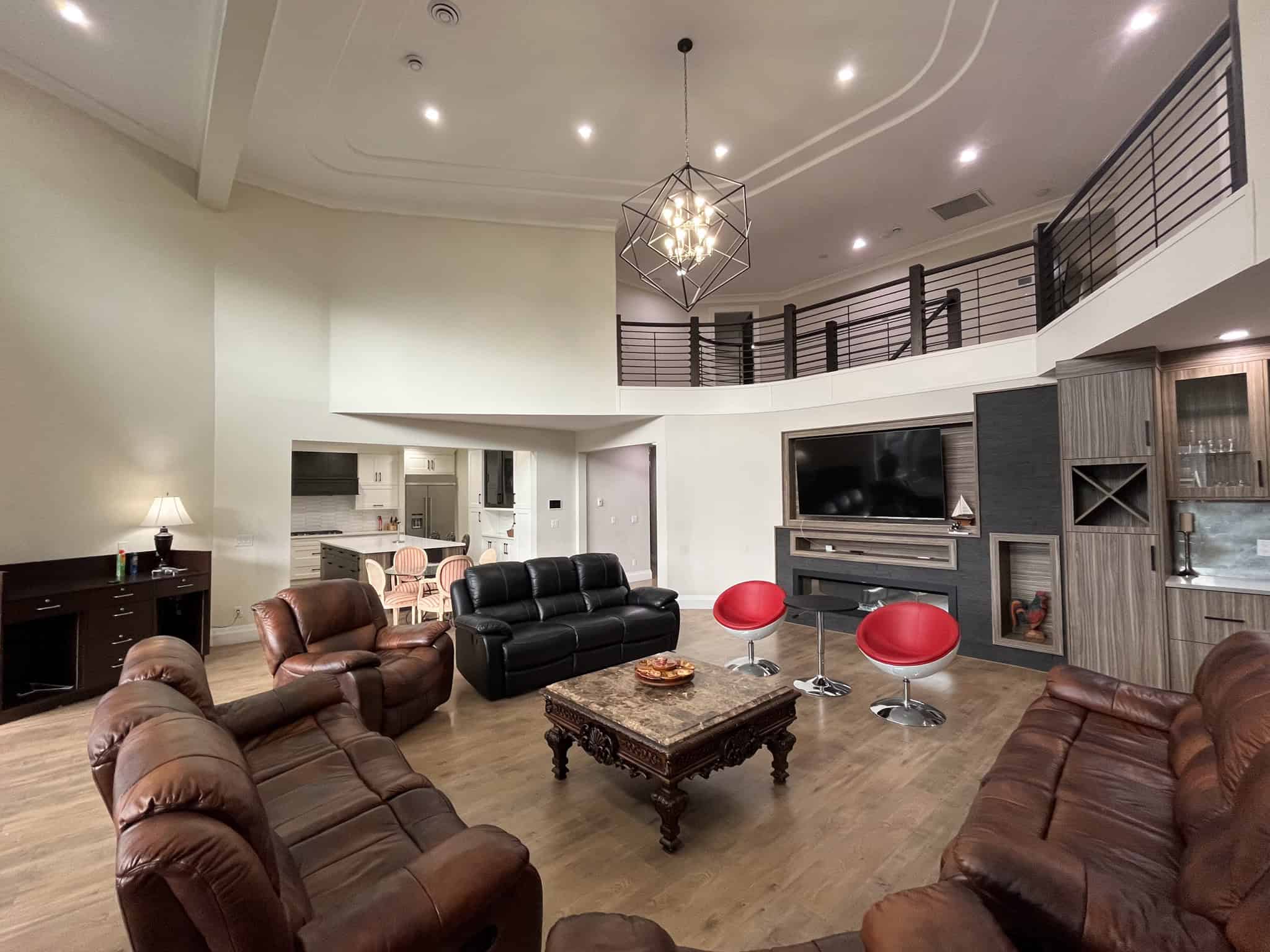 Elegant living room with modern and cozy furniture, high ceilings, and stylish lighting, showcasing luxury home interiors by Orca Realty Inc. in Vancouver.