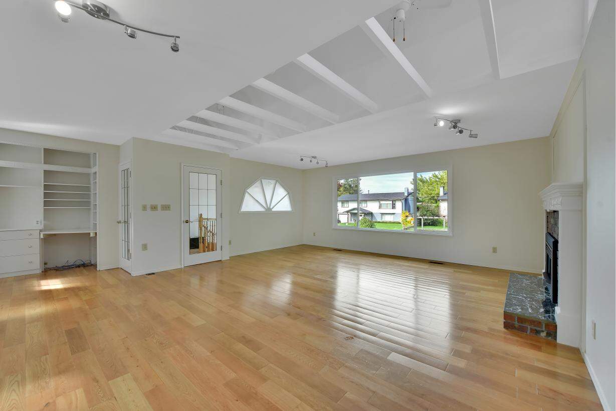 Bright spacious living room with large windows, hardwood flooring, modern interior design, fireplace, and ample natural light, Perfect for Vancouver residential real estate listings.